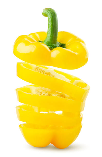 istock Yellow bell pepper cut into pieces falling on a white background. Isolated 1296895585