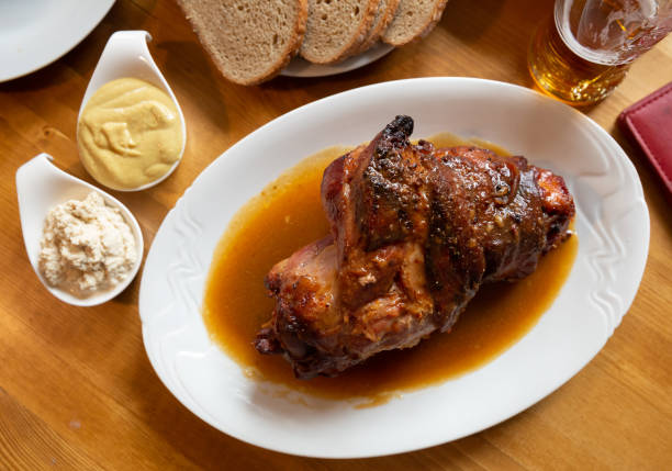 istock Fried pork knuckle (boar knee) with mustard and horseradish. Traditional czech dish 1296897971
