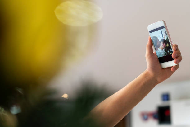 istock Hand of a person making video call during Christmas 1296898013