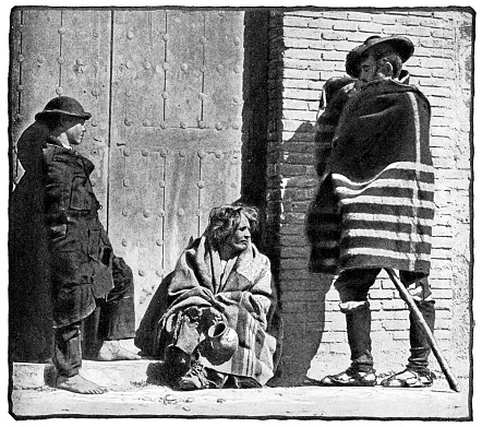 Homeless people on the street in Seville, Spain. Vintage halftone etching circa 19th century.