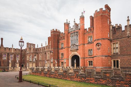 The royal courtyard entrance to the 16th century Hampton Court Palace, residence of Henry VIII at Richmond Upon Thames, in London, England.