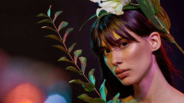 istock Lady with a plant staring at the camera 1296900771