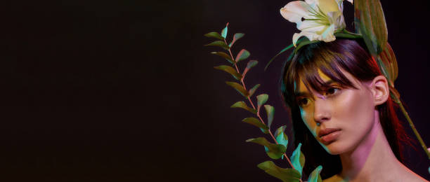 istock Woman looking at a plant before her 1296903946