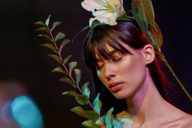 istock Female with a flower closing her eyes 1296904510