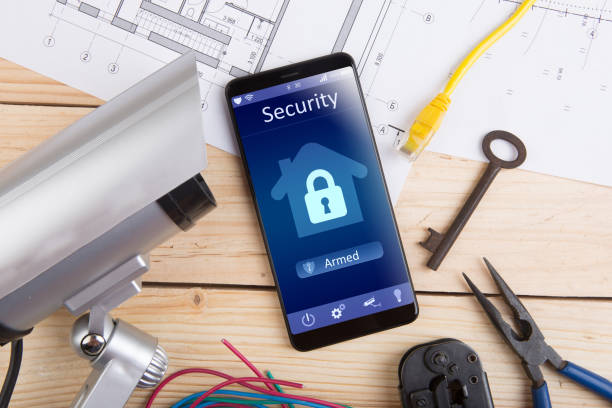 istock Home security concept smartphone with smart home app and surveillance cctv camera on the desk 1296905880