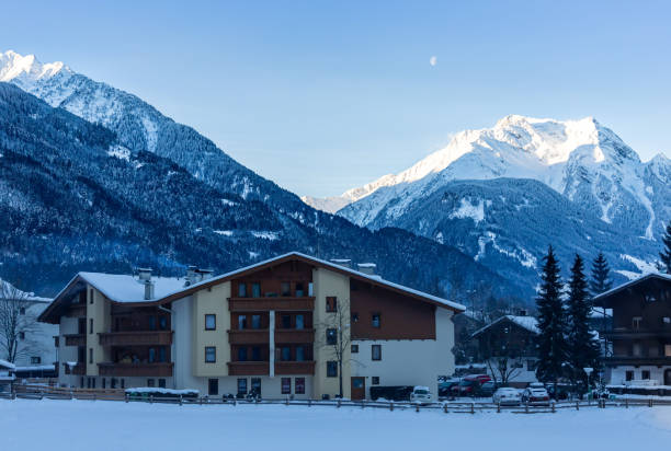 istock Sun shines on snow covered mountains 1296907150