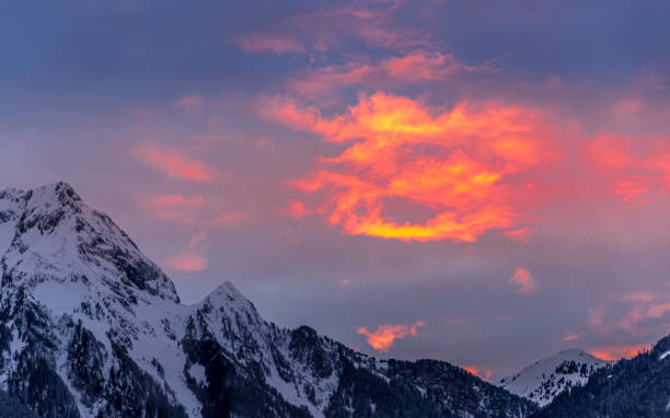 istock Clouds appear painted with bright red and orange in beautiful winter sunset 1296907320