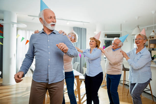 istock Seniors celebrating birthday with friends dancing having fun 1296908202