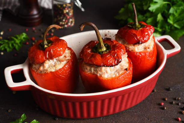 istock Stuffed peppers baked with meat and rice on a dark concrete background 1296910841