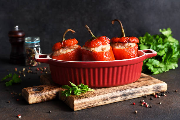 istock Stuffed peppers baked with meat and rice on a dark concrete background 1296910863