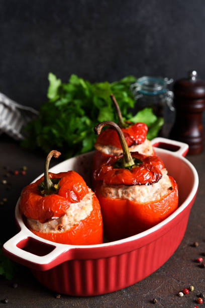 istock Stuffed peppers baked with meat and rice on a dark concrete background 1296910876