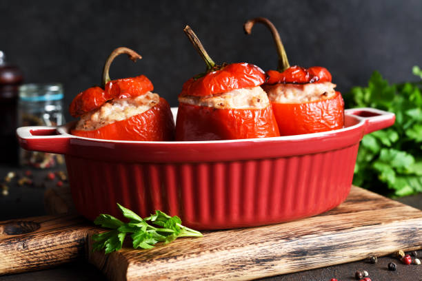 istock Stuffed peppers baked with meat and rice on a dark concrete background 1296910899