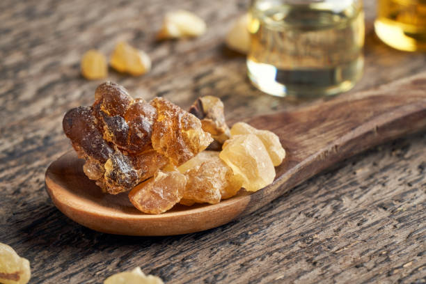 istock Frankincense resin on a wooden spoon on a table 1296911195