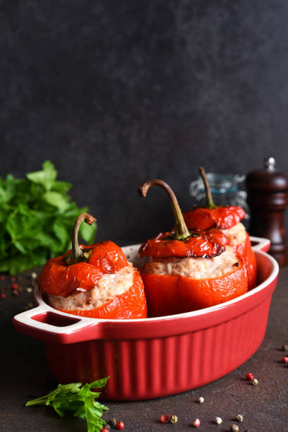 istock Stuffed peppers baked with meat and rice on a dark concrete background 1296911222