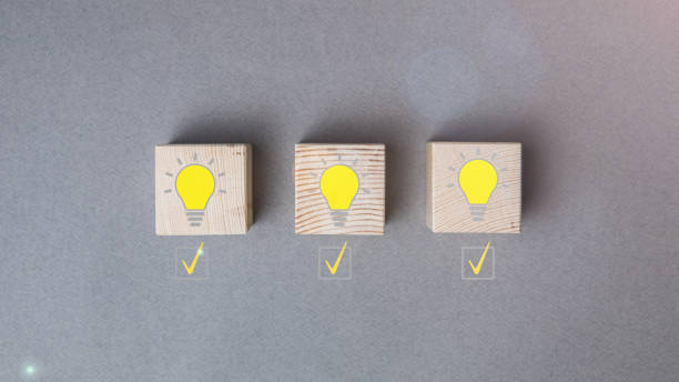 istock Creative idea, new idea, innovation and solution concept. wooden cubes with yellow light bulb symbol on the table, yellow, copy space 1296911957