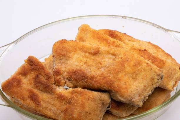 istock Breaded fish fillets in a glass, heat-resistant dish 1296912234