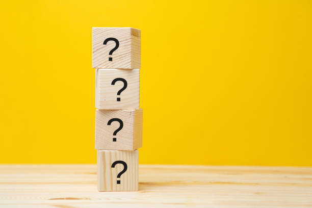 istock Cubes with question marks on a yellow background, close-up. Space for text 1296913227