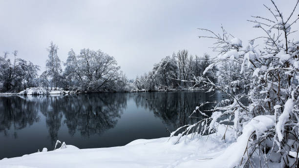 istock Snowy landscape surrounding river 1296916799
