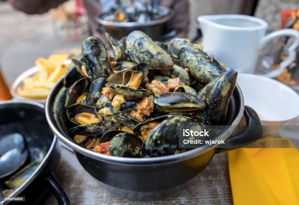 Tasty black mussels in sauce. Saint Malo, Brittany, France Cancale Stock Photo