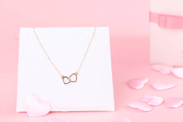 istock Valentines gift for her, bracelet with two hearts on a pink background, 1296917826