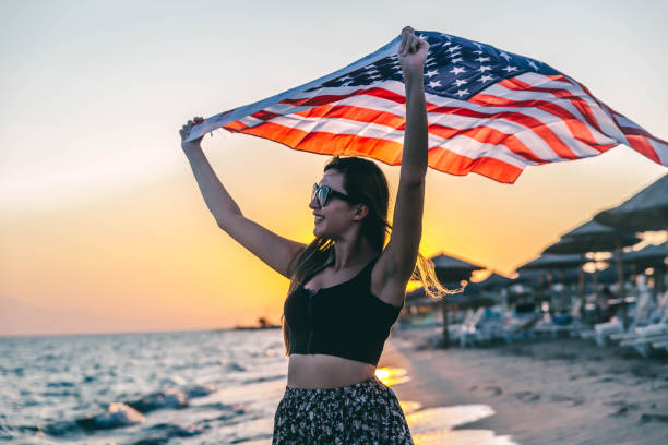 istock Smiling woman with American flag 1296919025