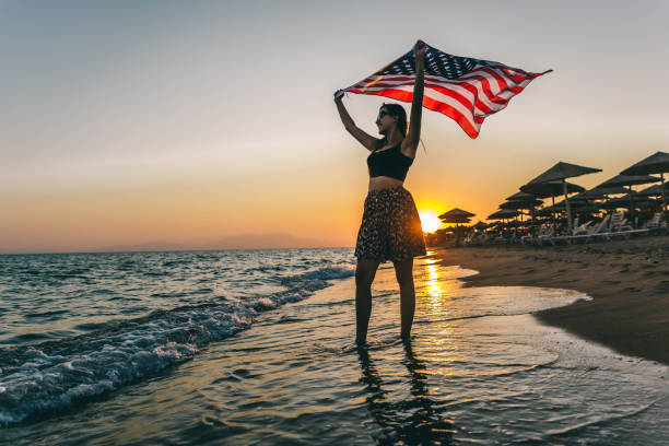 istock Smiling woman with American flag 1296919232