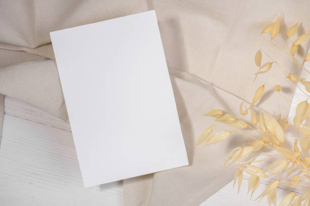 istock Card mockup template, empty stationery card with dry plants flower 1296919599