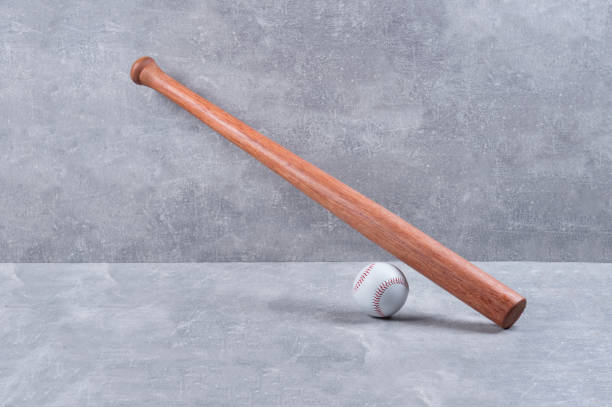 istock Baseball bat and ball on a concrete background. Sport team concept 1296920231