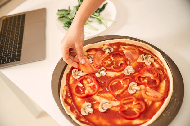 istock Making vegetarian pizza at home with delicious ingredients 1296921665