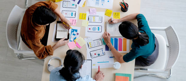 istock Brainstorm planing creative asian teamwork, Group of asia mobile phone app developer team meeting for ideas about screen display prototype smartphone layout, ux startup small business 1296922352