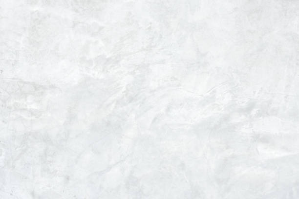 istock White concrete stone surface paint wall background, Grunge cement paint texture backdrop, White rough concrete stone wall background, Copy space for interior design background, banner, wallpaper 1296922410