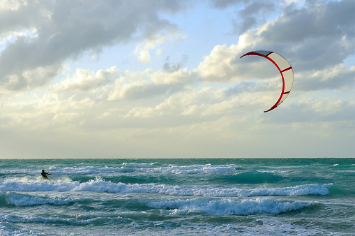 Man kite-surfing in Atlantic Ocean in stormy weather