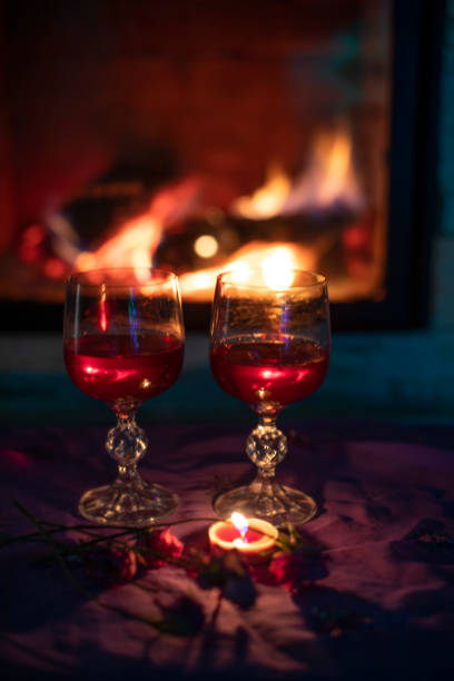 istock two glasses with red wine, near the fireplace, evening, vertical 1296922718