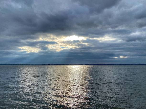 istock Sunbeams Pierce The Storm Clouds Over Charleston Harbor 1296926512
