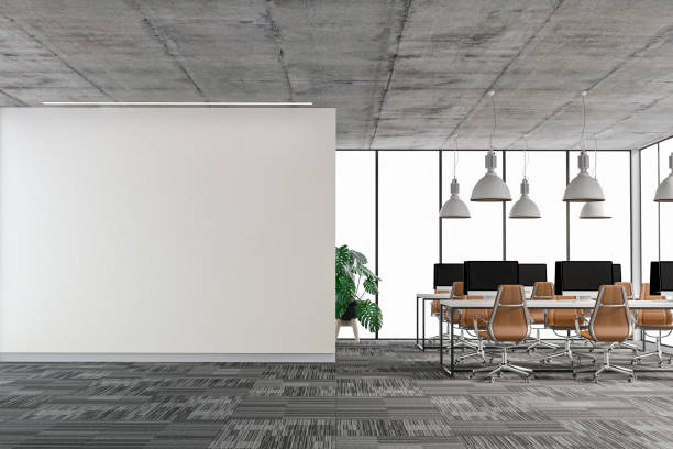 istock Empty office interior with copy space and wordesks on carpet floor stock photo 1296927741