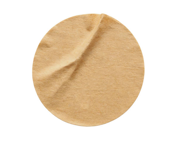 istock Brown round paper sticker label isolated on white background 1296931023