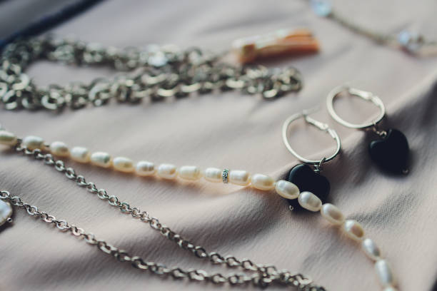 istock White pearls on the white silk as wedding background. 1296932182
