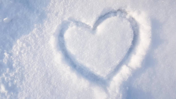 heart drawn on the snow in the park. Valentine's Day, winter vacation in the city stock photo