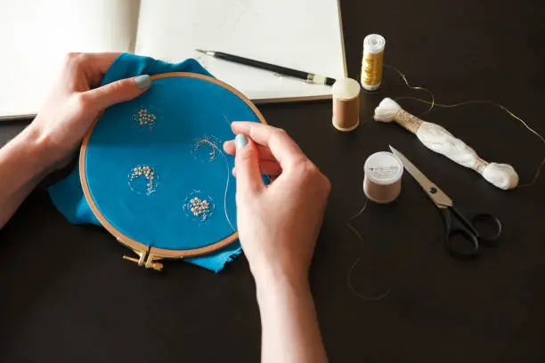 Workplace of an embroiderer with couture embroidery on a hoop