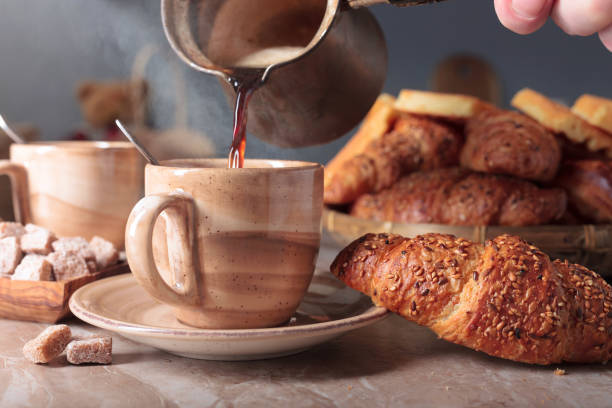 istock Fresh croissants with sesame seeds and coffee. 1296941163