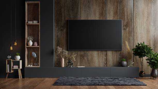 макет телевизионной стены, установленной в темной комнате с темной деревянной стеной. - digitally generated image indoors lifestyles technology стоковые фото и изображения