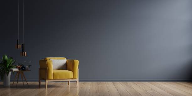 istock The interior has a yellow armchair on empty dark wall background. 1296943833