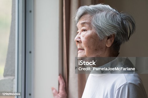 istock Serious Asian Senior Woman in 90s Looking Out of Window 1296945064