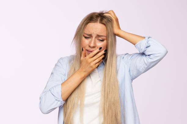 istock Worried female in difficult life situation, made a mistake, nervous, thinking, keeps hand on face and head 1296946287
