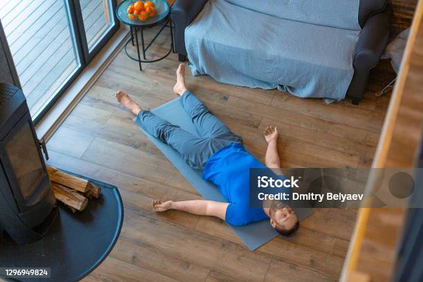 Relaxation Practice Yoga Shavasana Stock Photo - Download Image Now - Lying Down, Men, Yoga
