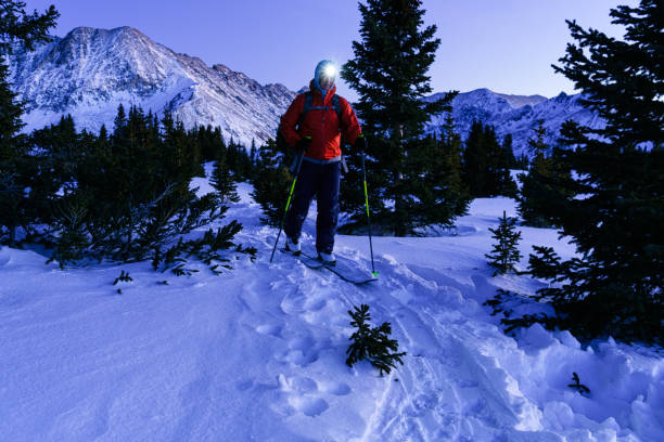 istock Ski Touring with Headlamp in Scenic Rugged Mountains 1296950019