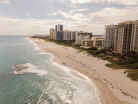 Aerial Views of Teal Ocean Waves Sweeping Across the North Palm Beach, Florida Seashore at Mid-Day in January of 2021