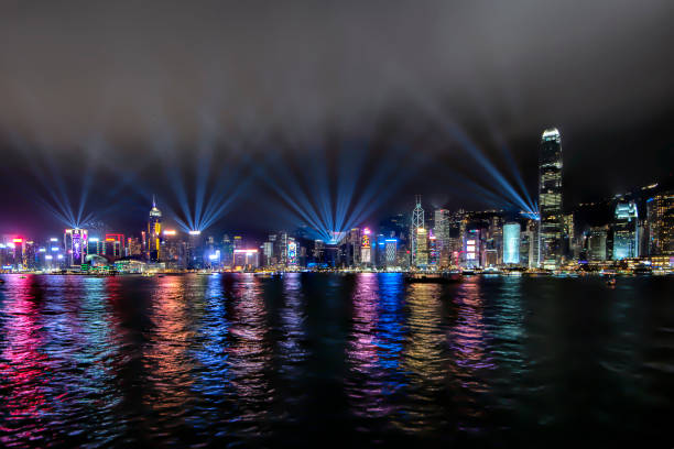 Illumination Light Up at Victoria Harbour Music Show called Symphony of Lights", Hong Kong Hong Kong - December 8, 2018 : Night View of Hong Kong Skyscraper Buildings with Flashing Lights at Victoria Harbour Music Show called Symphony of Lights" showing every night symphony orchestra photos stock pictures, royalty-free photos & images