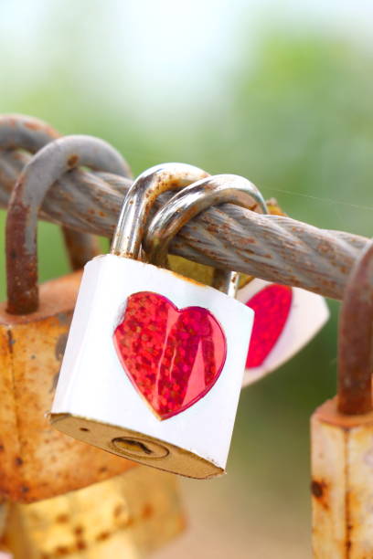 istock pair white key with red heart sticker and many old rust key lock with rust iron fence 1296956973