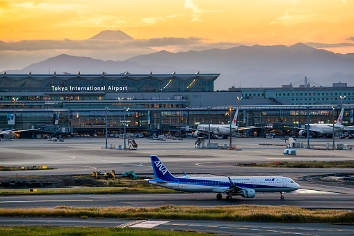 Japan - November 17, 2019 : ANA Aircraft taxiing on the runway of Haneda International Airport with Fuji Mountain Background, Tokyo